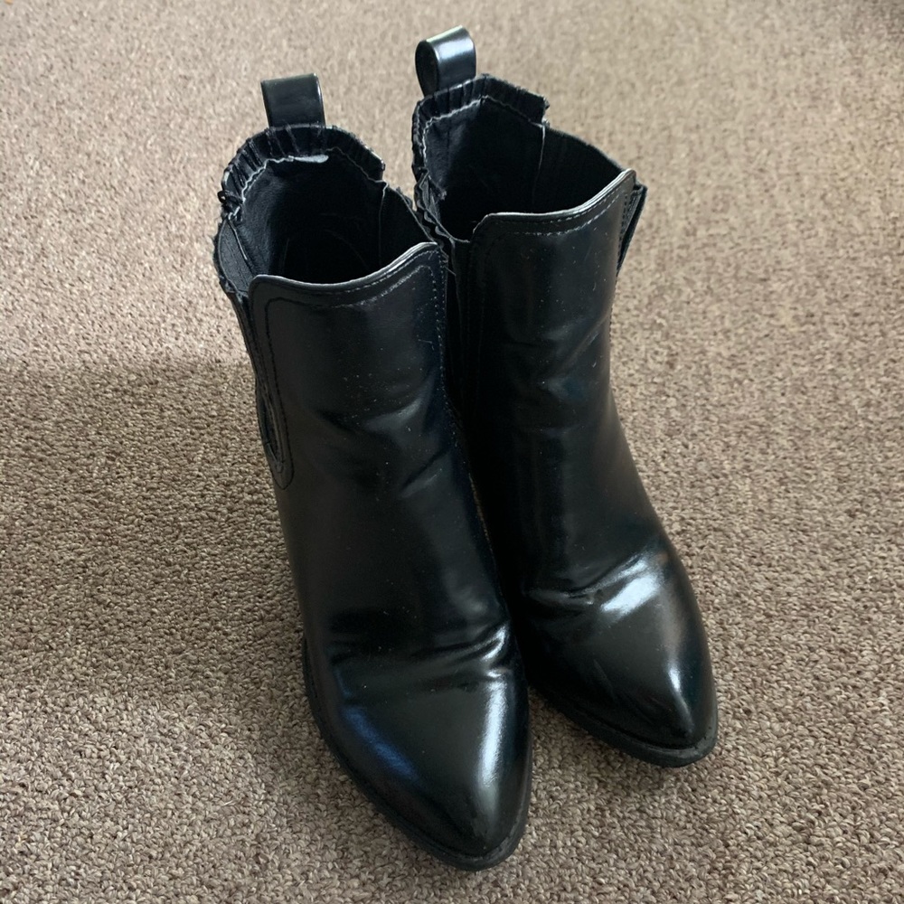 Boots with metal covered cut heel design
